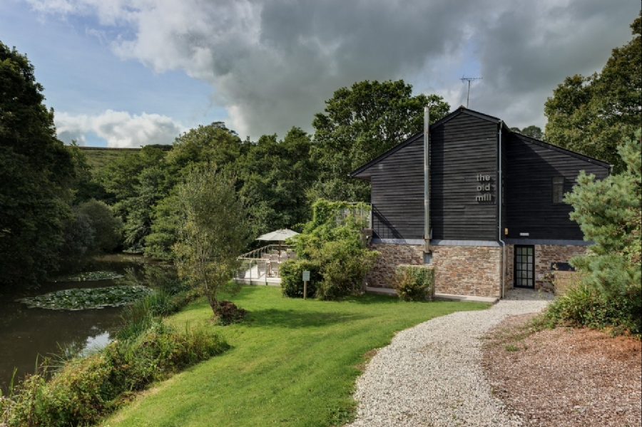 The black-timber mill building above the lake at Stonerush Lakes